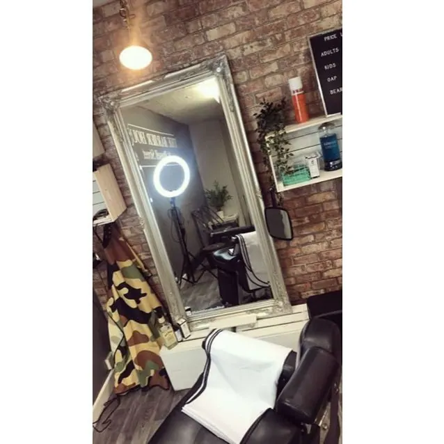 Inside The Barber House: the chair, mirror and brick wall
